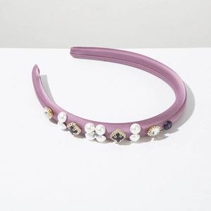 Detail of purple padded headband with faux pearls and sparkling rhinestones flowers