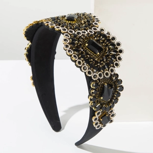 Luxury Baroque black crystal padded headband with gold metal accents on white background