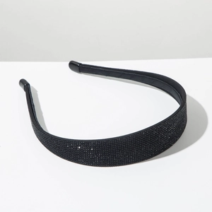 Macro view showing the sleek black rhinestone detailing and protective end caps of the headband