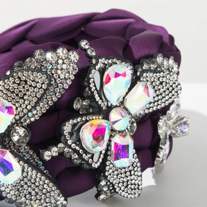 Macro detail of luxury braided velvet headband with sparkling crystal butterfly embellishments