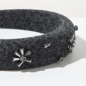 Detailed macro view of wool felt headband with hand-stitched crystal floral patterns