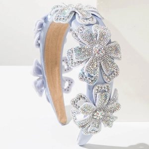 Detail of light blue velvet headband with 3D rhinestone flowers and sparkling crystals