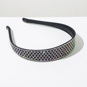 Detailed macro view of black headband with colorful rhinestones in a diamond grid pattern