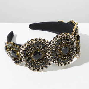 Detail of baroque wide headband with black velvet, gold metal studs and faceted crystals