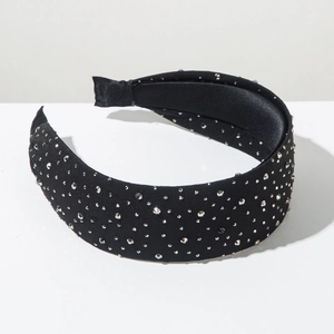 Detail view of a wide black headband featuring sparkling silver rhinestones on satin fabric