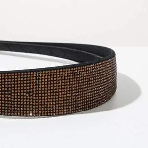 Detail of amber crystal rhinestones on a minimalist slim black velvet headband