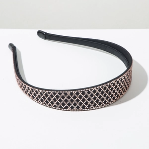 Detail view of black headband with rose gold rhinestones in a diamond lattice pattern