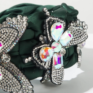 Detail of luxury green silk headband with handcrafted sparkling butterfly crystal decor