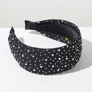Detailed view of black wide headband with sparkling white rhinestones on fabric base