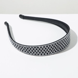 Close-up of luxury black headband with diamond lattice pattern and soft plastic tips