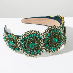 Detail of emerald green velvet headband with baroque crystal flower embellishments