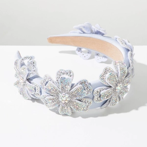 Detailed view of light blue headband with five large flowers encrusted in AB rhinestones