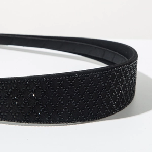Macro shot of luxury black headband with sparkling rhinestones in a rhombic pattern