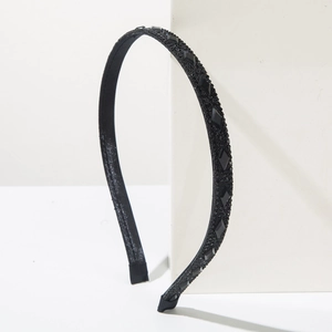 Detail shot of black headband with micro-diamonds and large rhombic faceted black gems
