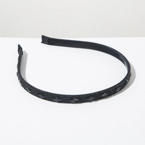 Detailed view of elegant black slim headband with shimmering rhinestones and large gemstones