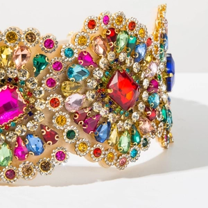 Macro shot of colorful pear-cut crystals on luxury gold baroque headband detail