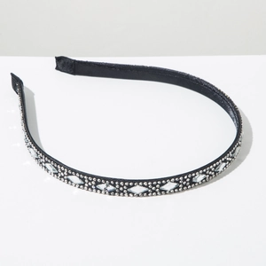 Detail of elegant black satin headband with sparkling white rhinestones and pearls