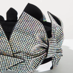 Close-up of shimmering AB crystals meticulously set on a black fabric headband bow