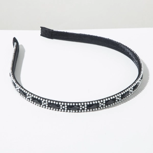 Detailed macro view of retro headband with white pearls and black diamond crystals