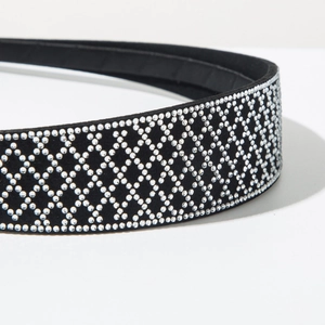 Detail of luxury rhinestone headband featuring diamond-patterned crystals on black velvet