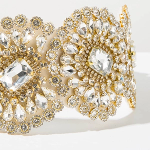 Macro detail of luxury baroque headband featuring glittering crystals on gold frame