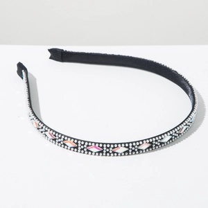 Close-up of black fabric headband featuring white pearls and colorful rhinestones