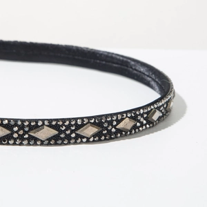 Detail of vintage headband with black fabric base and dark grey rhinestone studs