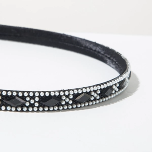 Close-up of black satin headband featuring elegant white pearls and sparkling black rhinestones