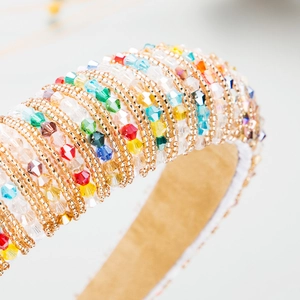 Macro detail of handmade baroque headband featuring multicolored crystal beads and gold seeds