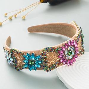 Detailed macro view of sparkling rhinestone floral and heart patterns on the velvet headband