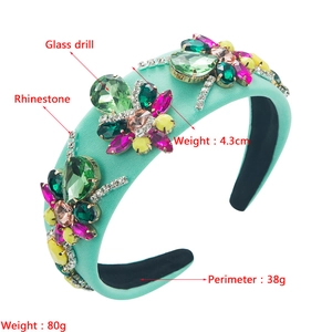 Close-up of mint green velvet headband featuring colorful rhinestones and floral crystals
