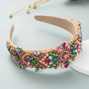 Detail of luxury padded headband with colorful rhinestones and pink pearls on satin