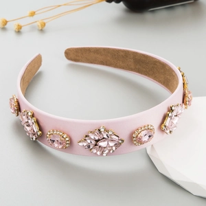 Detail of pink satin headband with vintage crystal embellishments and velvet lining