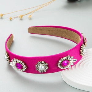 Detail view of fuchsia baroque headband with crystal floral clusters and white pearls
