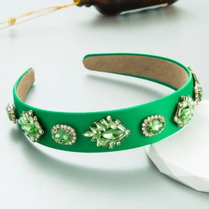 Detail of green silk padded headband with baroque emerald crystals and rhinestones