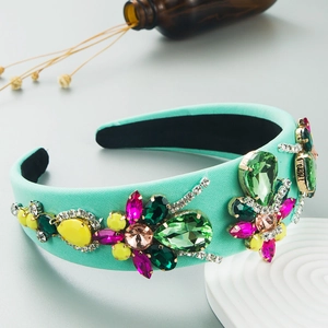 Detailed side view of mint green padded headband with colorful oversized crystals
