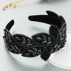 Close-up of Baroque black headband with intricate leaf beadwork and silver detailing