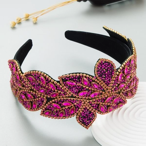 Detailed close-up of pink rhinestones and beads on a baroque wide velvet headband