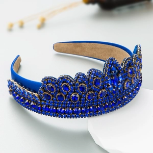 Detailed side view of a baroque crown headband with deep blue crystals and ornate jewels