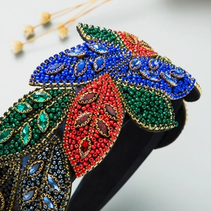 Close-up of Baroque style wide headband with colorful beads and marquise rhinestones