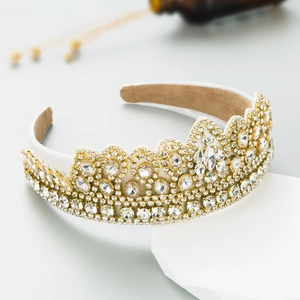 Baroque gold crown headband with sparkling crystals and clear rhinestones on display