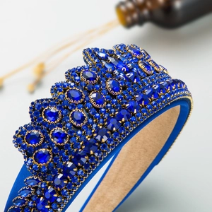 Detail of royal blue baroque headband with sparkling crystals and gold woven edges