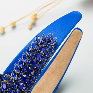 Macro shot of royal blue baroque headband with sparkling crystals and satin finish