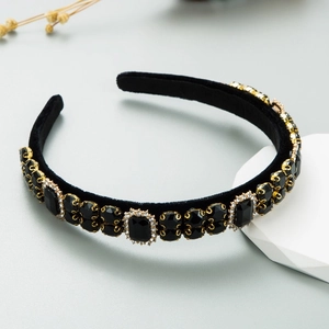 Detail of baroque black velvet headband featuring luxury colorful crystals in gold settings