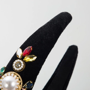 Macro shot of luxury velvet headband with colorful rhinestones and faux pearls detail