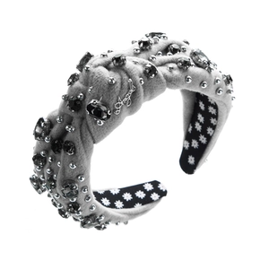 Close-up of gray velvet headband with beads, rhinestones and metal Angel logo