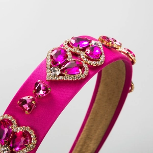 Baroque style wide satin headband in rose pink featuring sparkling crystal heart embellishments