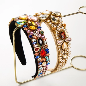 Baroque padded headband featuring colorful rhinestones and pearls on a gold stand