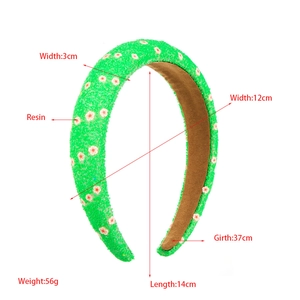 Detailed view of green flower headband with fabric texture and size specifications