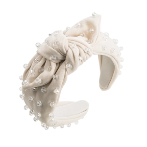 Detail of beige knotted fabric headband with hand-sewn transparent crystal bead embellishments
